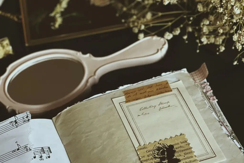 Vintage hand mirror and sheet music representing a creative legacy