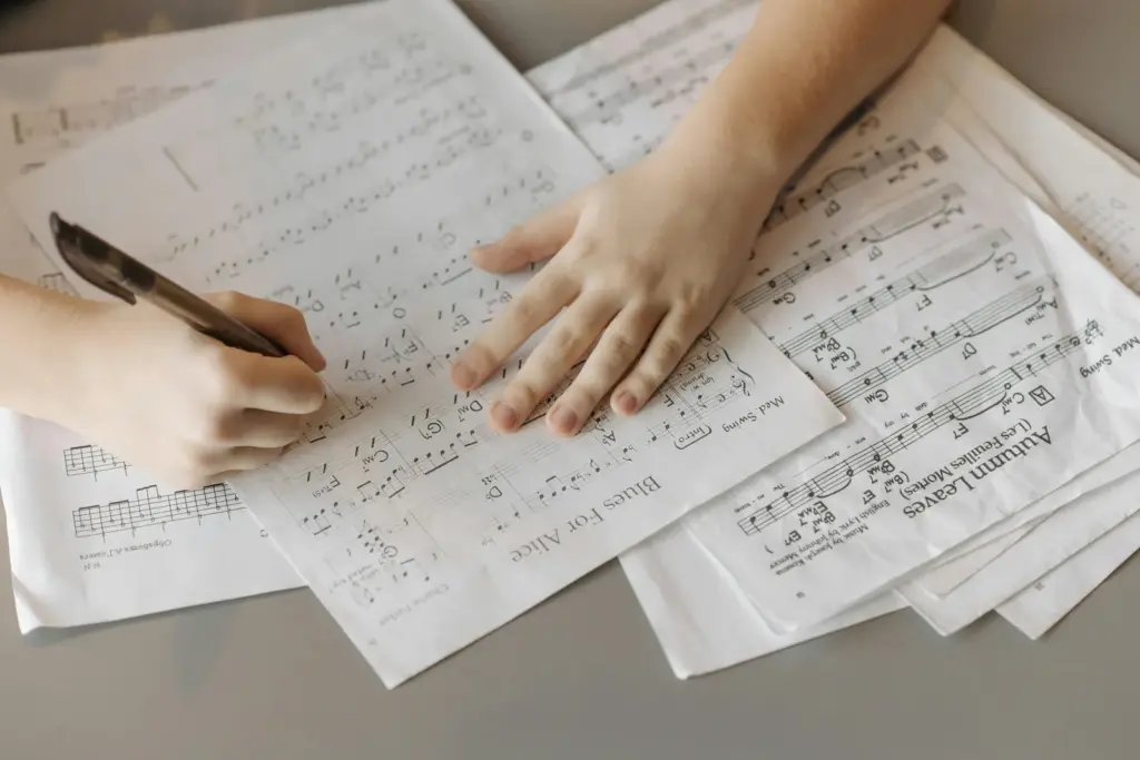 Songwriter writing a composition on sheet music